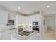 Modern kitchen with white cabinets, stainless steel appliances, and a functional island layout at 6409 Moorings Point Cir # 102, Lakewood Ranch, FL 34202