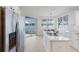 Bright kitchen with stainless steel appliances, waterfront views, and a seamless connection to the outdoors at 6409 Moorings Point Cir # 102, Lakewood Ranch, FL 34202