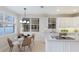 Bright eat-in kitchen with a waterfront view has stainless appliances and modern lighting at 6409 Moorings Point Cir # 102, Lakewood Ranch, FL 34202