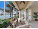 Inviting screened lanai overlooking the lake, furnished with comfortable seating, ideal for relaxation and enjoying nature at 6409 Moorings Point Cir # 102, Lakewood Ranch, FL 34202