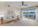 Bright living room with a lake view, neutral decor, and tile flooring at 6409 Moorings Point Cir # 102, Lakewood Ranch, FL 34202