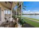 Inviting screened patio with comfortable seating and stunning lake views, perfect for relaxation at 6409 Moorings Point Cir # 102, Lakewood Ranch, FL 34202