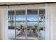 Screened patio with views of lake and seating at 6409 Moorings Point Cir # 102, Lakewood Ranch, FL 34202