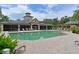 Inviting community pool with ample lounge chairs, a covered patio, and lush landscaping around the deck at 6409 Moorings Point Cir # 102, Lakewood Ranch, FL 34202