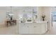 Contemporary wet bar with white cabinetry, offering a seamless transition to the dining area at 6409 Moorings Point Cir # 102, Lakewood Ranch, FL 34202