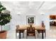 Dining room with modern lighting fixtures and view to kitchen at 117 S Polk Dr, Sarasota, FL 34236