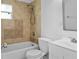 A renovated bathroom featuring tiled walls, new toilet and modern sink with stainless steel faucet at 1226 Coral Ridge Dr, Punta Gorda, FL 33950