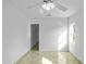 Bright bedroom with tile floors, ceiling fan, and natural light from the window at 1226 Coral Ridge Dr, Punta Gorda, FL 33950