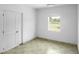 Bright bedroom featuring tile floors, a window with a view, and a convenient closet at 1226 Coral Ridge Dr, Punta Gorda, FL 33950
