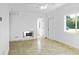 Bright living room with tile flooring, white walls, ceiling fan, and plenty of natural light at 1226 Coral Ridge Dr, Punta Gorda, FL 33950