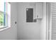 Utility room featuring a window and cabinet for storage with light switch and power outlet at 1226 Coral Ridge Dr, Punta Gorda, FL 33950