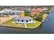 Aerial view highlighting waterfront location, landscaping, and canal access at 1327 Wesley Dr, Punta Gorda, FL 33950
