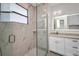 Modern bathroom featuring a glass shower, and an illuminated vanity mirror at 1327 Wesley Dr, Punta Gorda, FL 33950