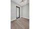 Bright bedroom featuring wood-style flooring, a modern light fixture, and clean, neutral wall colors at 1327 Wesley Dr, Punta Gorda, FL 33950