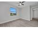 Cozy bedroom features a ceiling fan, tile floors, and a window with an exterior view at 1327 Wesley Dr, Punta Gorda, FL 33950