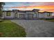 Stunning contemporary home at sunset, showcasing modern design and attractive driveway at 1327 Wesley Dr, Punta Gorda, FL 33950