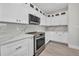 Modern kitchen featuring white cabinets, stainless steel appliances, and stylish countertops and backsplash at 1327 Wesley Dr, Punta Gorda, FL 33950