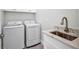 Well-equipped laundry room with modern washer, dryer, sink and stylish countertop at 1327 Wesley Dr, Punta Gorda, FL 33950