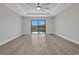 Bright living room features a ceiling fan, tile floors, and sliding glass doors with a waterfront view at 1327 Wesley Dr, Punta Gorda, FL 33950