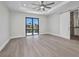 Bright main bedroom with tile floors, ceiling fan, sliding door access, and bathroom access at 1327 Wesley Dr, Punta Gorda, FL 33950
