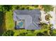 Aerial view of a home featuring a screened pool, lake access and beautiful landscaping at 13616 Legends Walk Ter, Lakewood Ranch, FL 34202