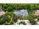 Aerial view of a home featuring a screened pool, lake access and beautiful landscaping at 13616 Legends Walk Ter, Lakewood Ranch, FL 34202