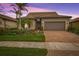Charming one-story home with a brick driveway, two-car garage, and lush landscaping at 13925 Miranese St, Venice, FL 34293