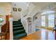 Bright foyer with stairway leading to second floor, with hardwood floors and lots of natural light at 145 Burns Rd, Terra Ceia, FL 34250