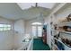 Upstairs hallway featuring built-in bookshelves and a glass-paneled door at 145 Burns Rd, Terra Ceia, FL 34250