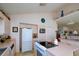 Bright kitchen with an island cooktop, appliances, and neutral color palette at 145 Burns Rd, Terra Ceia, FL 34250