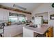 Bright kitchen with an island cooktop, decorative accents, and large window at 145 Burns Rd, Terra Ceia, FL 34250