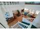 A high-angle view of a living room with wood floors, white railing, and plenty of natural light at 145 Burns Rd, Terra Ceia, FL 34250