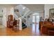 Open concept living room with stairway and lots of windows for natural light and wood flooring at 145 Burns Rd, Terra Ceia, FL 34250