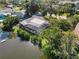 Aerial view of a beautiful home with a screened pool, overlooking a lake at 1705 Shoreland Dr, Sarasota, FL 34239