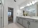 Bright bathroom featuring double vanities, white countertops, and a view into the connecting bedroom at 2930 61St E Dr, Ellenton, FL 34222