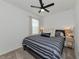 Comfortable bedroom with striped bedding, bedside tables, and soft, neutral colors at 2930 61St E Dr, Ellenton, FL 34222
