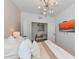 Cozy bedroom with a view into a seating area, modern lighting, and plush pillows at 2930 61St E Dr, Ellenton, FL 34222