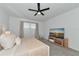 Bright bedroom featuring a ceiling fan, neutral decor, and a modern TV at 2930 61St E Dr, Ellenton, FL 34222