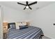 Cozy bedroom featuring a striped bedspread, soft lighting, and minimalist decor at 2930 61St E Dr, Ellenton, FL 34222