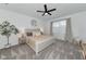 Bright bedroom featuring a ceiling fan, neutral decor, and an accent tree at 2930 61St E Dr, Ellenton, FL 34222