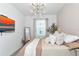 Comfortable bedroom with a neutral color palette and an elegant chandelier at 2930 61St E Dr, Ellenton, FL 34222