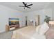 Well-lit bedroom featuring a modern TV, plush bedding, and stylish decor at 2930 61St E Dr, Ellenton, FL 34222