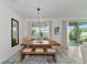 Open dining area with a large wood table, bench seating, decorative rug, and natural light at 2930 61St E Dr, Ellenton, FL 34222
