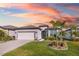 Well-maintained home with a lush front lawn, inviting curb appeal, and a colorful sunset backdrop at 2930 61St E Dr, Ellenton, FL 34222