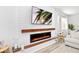 Shiplap accent wall with a sleek electric fireplace, wooden shelves, and modern decor at 2930 61St E Dr, Ellenton, FL 34222