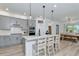 Open kitchen with an island and seating, stainless steel appliances, and a view to the dining area at 2930 61St E Dr, Ellenton, FL 34222