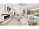 Open-concept living room featuring a modern fireplace, neutral-toned furniture, and ample natural light at 2930 61St E Dr, Ellenton, FL 34222