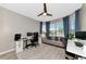 Home office space with large windows, neutral decor, and a ceiling fan at 2930 61St E Dr, Ellenton, FL 34222