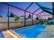 Screened pool with lighting, fountain features, and a fire pit area at 2930 61St E Dr, Ellenton, FL 34222