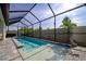 Screened pool with extensive brick paving, lush landscaping, and blue skies at 2930 61St E Dr, Ellenton, FL 34222
